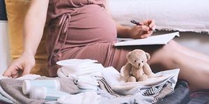 Hochschwangere packt Kliniktasche f&uuml;r die Geburt